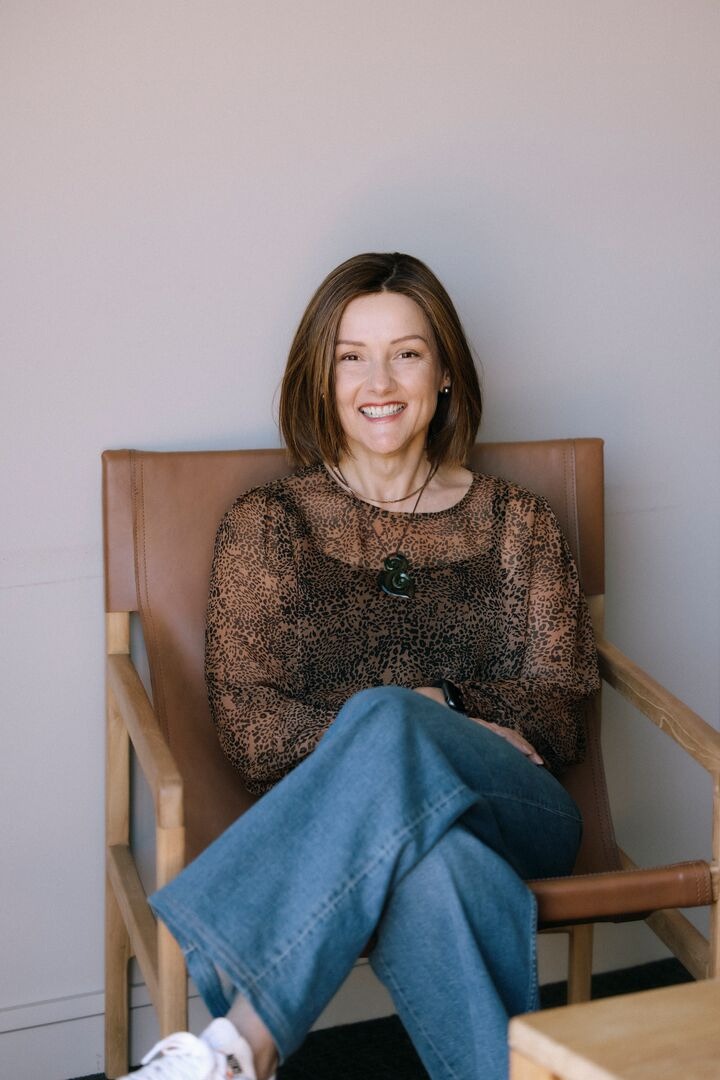 Nadia Ellis seated and smiling.
